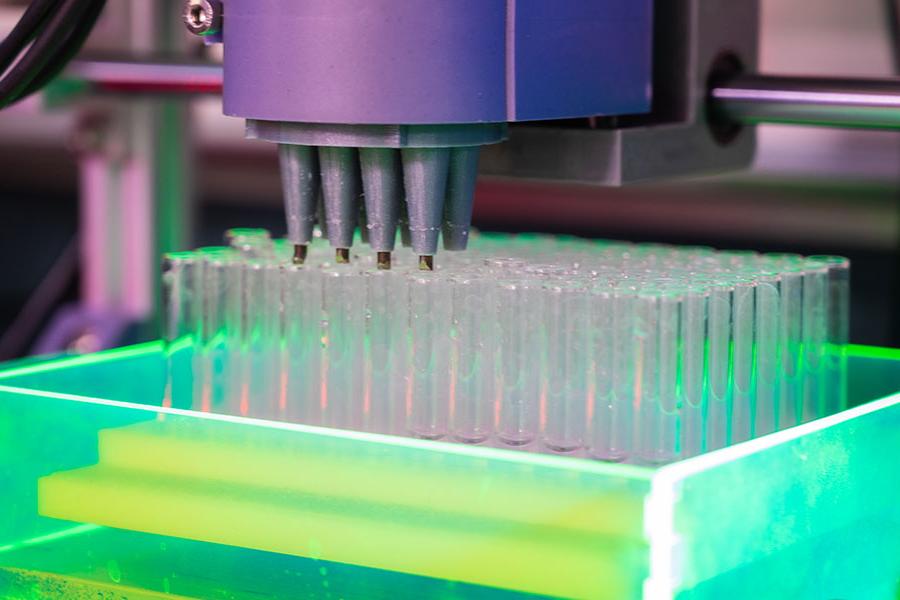 Fluorescent green test tubes in a lab.