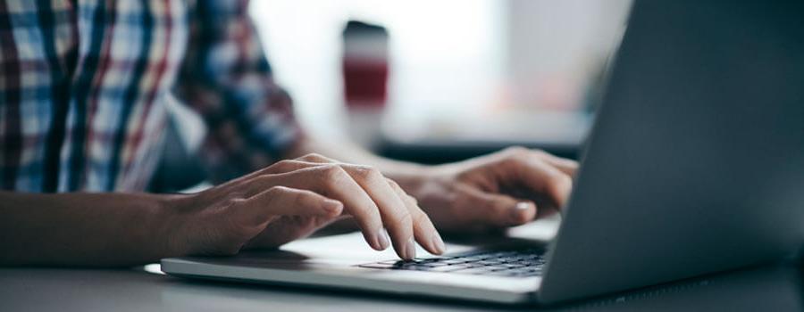 hands on a laptop keyboard